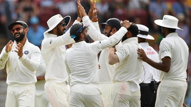 India's captain Virat Kohli (L) reacts with teammates after the dismissal of Australia's Peter Handscomb. (REUTERS)