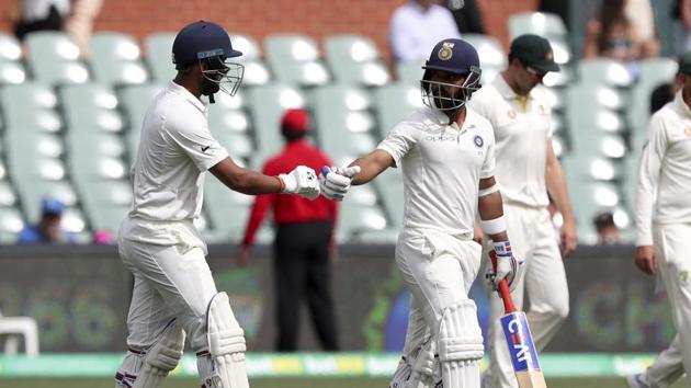 India's Ajinkya Rahane, right, and Cheteshwar Pujara walk out to bat on day four of the first Test between Australia and India. (AP) India's Ajinkya Rahane, right, and Cheteshwar Pujara walk out to bat on day four of the first Test between Australia and India. (AP)