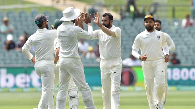 Indian players celebrate the fall of an Australia wicket at the Adelaide Oval on Sunday.(AFP)