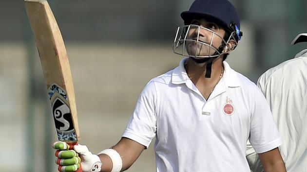 Gautam Gambhir raises his bat after scoring a century during the Ranji Trophy group league match between Delhi and Andhra.