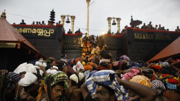 Devotees climb over the holy eighteen golden steps to worship diety of Hindu god Ayyapa at a temple premises in Sabarimala. (HT file photo) Devotees climb over the holy eighteen golden steps to worship diety of Hindu god Ayyapa at a temple premises in Sabarimala. (HT file photo)
