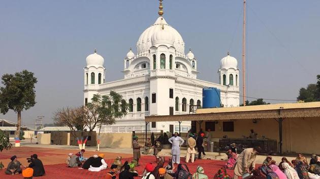 Sikh Pilgrims sit in front of Kartarpur Gurdwara Sahib(AFP)