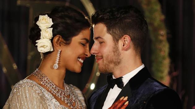 Priyanka Chopra and musician Nick Jonas pose for photographs at their wedding reception in New Delhi.(AP)