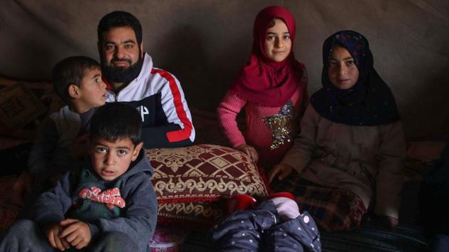 Maya Merhi (2nd R) sits with her family inside their tent. Born with no legs due to a congenital condition, Mehri can now walk with new prosthetics after undergoing treatment in Turkey. Pictures of her plight, including those taken by AFP in Syria, were seen around the world in June, and she was taken to Istanbul for the life-changing procedure. (Aaref Watad / AFP) Maya Merhi (2nd R) sits with her family inside their tent. Born with no legs due to a congenital condition, Mehri can now walk with new prosthetics after undergoing treatment in Turkey. Pictures of her plight, including those taken by AFP in Syria, were seen around the world in June, and she was taken to Istanbul for the life-changing procedure. (Aaref Watad / AFP)