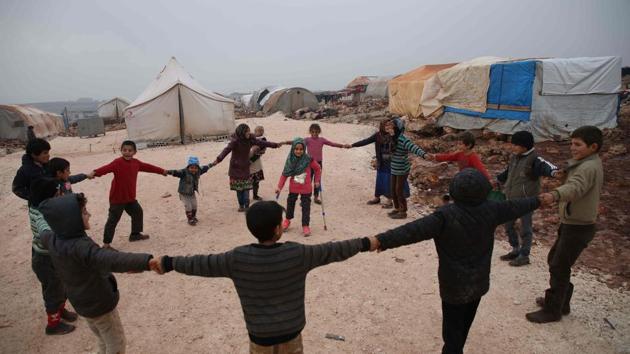 Maya Merhi stands in the middle as her friends surround her in the IDP camp of Serjilla. Mehri was finally able to joined in the games and dancing with the other children at the camp. (Aaref Watad / AFP) Maya Merhi stands in the middle as her friends surround her in the IDP camp of Serjilla. Mehri was finally able to joined in the games and dancing with the other children at the camp. (Aaref Watad / AFP)