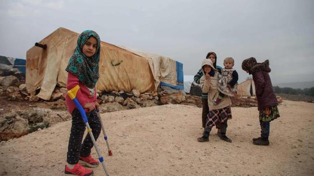 Syrian Maya Merhi stands with her friends in the Internally Displaced Persons (IDP) camp of Serjilla in northwestern Syria next to Bab al-Hawa border crossing with Turkey, on December 9, 2018. Until a few days ago, eight-year-old Merhi had to struggle around the camp on artificial limbs made of plastic tubing and tin cans. (Aaref Watad / AFP) Syrian Maya Merhi stands with her friends in the Internally Displaced Persons (IDP) camp of Serjilla in northwestern Syria next to Bab al-Hawa border crossing with Turkey, on December 9, 2018. Until a few days ago, eight-year-old Merhi had to struggle around the camp on artificial limbs made of plastic tubing and tin cans. (Aaref Watad / AFP)