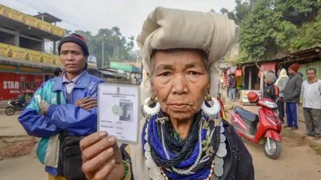 Mizoram exit polls 2018: Kanhmun: A Bru tribal woman shows her identity card as she waits to cast her vote at a polling station for the state Assembly elections, at Kanhmun, Mizoram.(PTI)