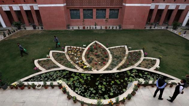 People walk inside the premises of India's ruling Bharatiya Janata Party (BJP) headquarters in New Delhi.(REUTERS)