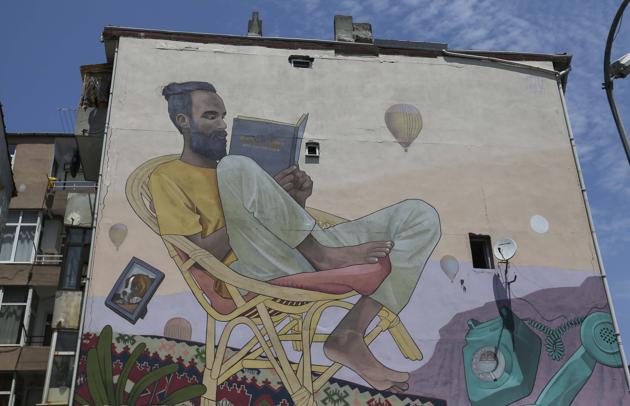 Nothing like a good book: A mural by Artez, an artist from Serbia, on a building in Istanbul, Turkey. The mural was created as part of the 7th Mural Istanbul Street Art Festival in July 2018.(Getty Images)