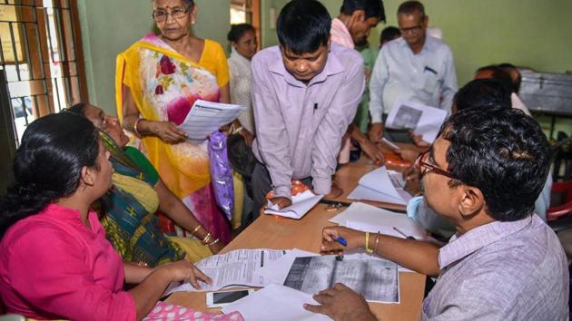 People verify the National Register of Citizens (NRC) forms to file claims and objections at an NRC centre, in Guwahati. (PTI file photo) People verify the National Register of Citizens (NRC) forms to file claims and objections at an NRC centre, in Guwahati. (PTI file photo)