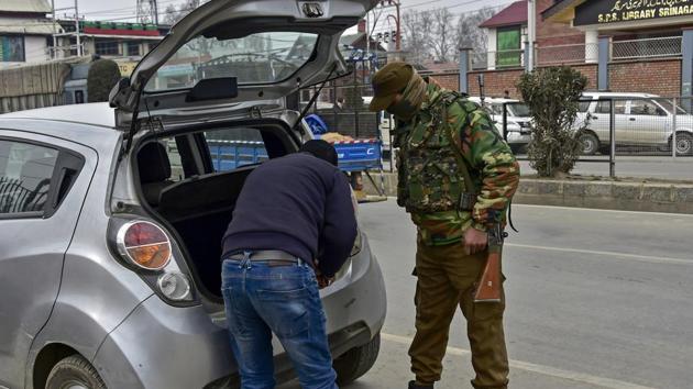 A policeman checks a vehicle at a temporary check point as a response to heightened security after 4 policemen were killed in a militant attack at Shopian district's Zainapora area yesterday, in Srinagar. (S Irfan / PTI) 