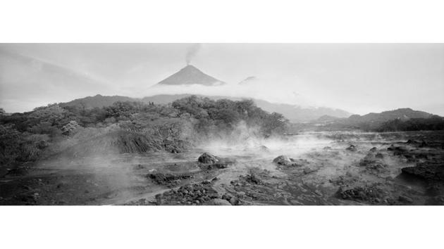 Steam rises from the terrain in San Miguel Los Lotes, Guatemala devastated by an eruption of the Volcano de Fuego, pictured in the background. On June 3, the mountain erupted with a fury not seen in more than a century, exploding with 1,300-degree molten rocks and black clouds of ash that smothered villages and buried at least 194 people alive. (Rodrigo Abd / AP) Steam rises from the terrain in San Miguel Los Lotes, Guatemala devastated by an eruption of the Volcano de Fuego, pictured in the background. On June 3, the mountain erupted with a fury not seen in more than a century, exploding with 1,300-degree molten rocks and black clouds of ash that smothered villages and buried at least 194 people alive. (Rodrigo Abd / AP)