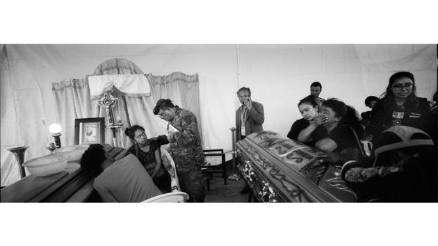 A military chaplain attempts to comfort survivors Francisca Nij and her brother Francisco, during their mother’s wake, who died in the eruption, in Alotenango. The June 3 eruption has 194 people recorded killed. Another 234 are officially missing, although organizations supporting the communities insist there are thousands more missing. (Rodrigo Abd / AP) A military chaplain attempts to comfort survivors Francisca Nij and her brother Francisco, during their mother’s wake, who died in the eruption, in Alotenango. The June 3 eruption has 194 people recorded killed. Another 234 are officially missing, although organizations supporting the communities insist there are thousands more missing. (Rodrigo Abd / AP)