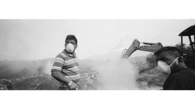 Peering through his lens, he found Elmer Vazquez searching for his wife and five children where he thought the family home had been. His wife was cooking lunch, their five children finishing homework when the eruption occurred. The farmer looked destroyed as he climbed into pits dug by a backhoe whenever he saw human remains or bits of torn clothing that could have belonged to his family. (Rodrigo Abd / AP) Peering through his lens, he found Elmer Vazquez searching for his wife and five children where he thought the family home had been. His wife was cooking lunch, their five children finishing homework when the eruption occurred. The farmer looked destroyed as he climbed into pits dug by a backhoe whenever he saw human remains or bits of torn clothing that could have belonged to his family. (Rodrigo Abd / AP)