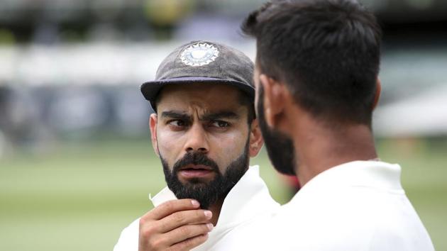 Man of the match India's Cheteshwar Pujara, right, talks with his captain Virat Kohli after his team's 31 run win over Australia to win the first cricket test in Adelaide.(AP)