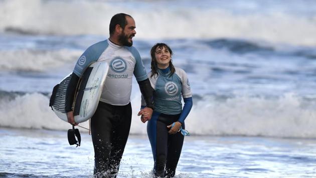 Garcia, who swims next to Lopez when she surfs, is her ‘eyes’ when it comes to telling her about a wave coming up. “A single whistle means the wave is coming on her right side, and a double whistle, on her left side,” he said, likening the signals to the way dolphins communicate. (Eloy Alonso / REUTERS) Garcia, who swims next to Lopez when she surfs, is her ‘eyes’ when it comes to telling her about a wave coming up. “A single whistle means the wave is coming on her right side, and a double whistle, on her left side,” he said, likening the signals to the way dolphins communicate. (Eloy Alonso / REUTERS)