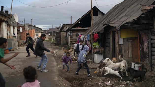 People run during a dog fight in a village near Kezmarok. Officials at several other hospitals in the region estimated that about 10-25% of Roma women slip out within two days of giving birth. In 2014, the government passed a law penalizing women who abscond, by withholding social benefits of up to 800 euros. Critics say the law unfairly targets Roma women, they typically have few resources. (Felipe Dana / AP) People run during a dog fight in a village near Kezmarok. Officials at several other hospitals in the region estimated that about 10-25% of Roma women slip out within two days of giving birth. In 2014, the government passed a law penalizing women who abscond, by withholding social benefits of up to 800 euros. Critics say the law unfairly targets Roma women, they typically have few resources. (Felipe Dana / AP)