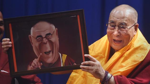 Spiritual leader Dalai Lama gestures as he holds a caricature during the 11th Silver Lecture Series, where the 83-year-old leader spoke on ‘The Compassion and the Need for Universal Responsibility’, at Guru Nanak College in Mumbai. (Shashank Parade / PTI) Spiritual leader Dalai Lama gestures as he holds a caricature during the 11th Silver Lecture Series, where the 83-year-old leader spoke on ‘The Compassion and the Need for Universal Responsibility’, at Guru Nanak College in Mumbai. (Shashank Parade / PTI)