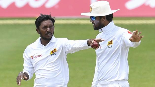 File image - Akila Dananjaya (L) and Dinesh Chandimal (R) of Sri Lanka set the field during a Test match.(AFP)