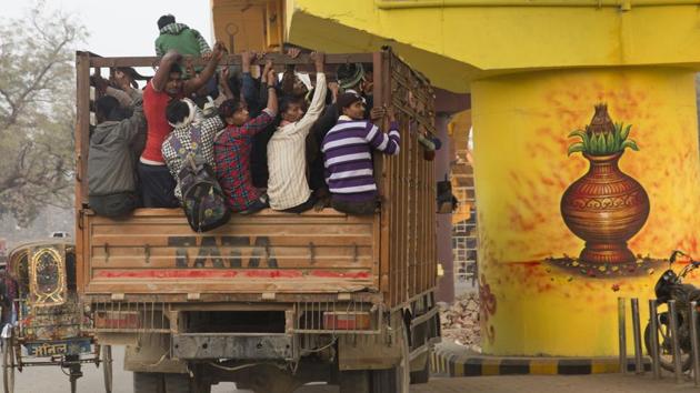 Villagers return to their homes on a truck after the day’s work past a painting on a flyover pillar, made as part of city beautification ahead of Kumbh Mela festival in Prayagraj, Uttar Pradesh. The 45-day Kumbh Mela starting from January 2019, is expecting millions of Hindu devotees to attend with the belief that taking a dip in the holy waters will cleanse them of their sins. (Rajesh Kumar Singh / AP) Villagers return to their homes on a truck after the day’s work past a painting on a flyover pillar, made as part of city beautification ahead of Kumbh Mela festival in Prayagraj, Uttar Pradesh. The 45-day Kumbh Mela starting from January 2019, is expecting millions of Hindu devotees to attend with the belief that taking a dip in the holy waters will cleanse them of their sins. (Rajesh Kumar Singh / AP)