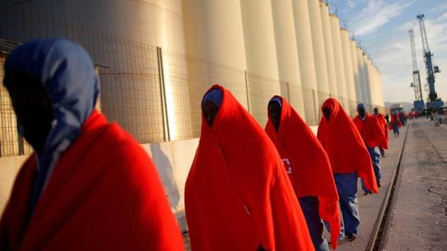 Migrants, intercepted off the coast in the Mediterranean Sea, walk after disembarking a rescue boat at dawn at the port of Malaga, southern Spain. (Jon Nazca / REUTERS) Migrants, intercepted off the coast in the Mediterranean Sea, walk after disembarking a rescue boat at dawn at the port of Malaga, southern Spain. (Jon Nazca / REUTERS)