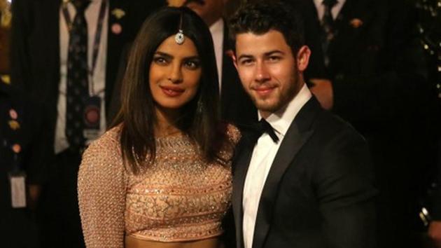 Actress Priyanka Chopra and her husband Nick Jonas arrive to attend the wedding ceremony of Isha Ambani.(REUTERS)