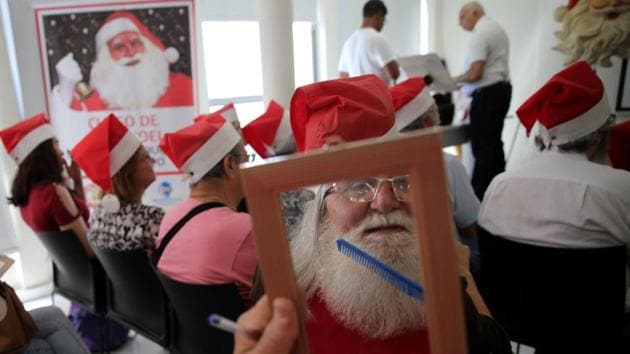 A students at Santa Claus school takes a quick grooming break during a class in Sao Paulo, Brazil. (Paulo Whitaker / REUTERS) A students at Santa Claus school takes a quick grooming break during a class in Sao Paulo, Brazil. (Paulo Whitaker / REUTERS)