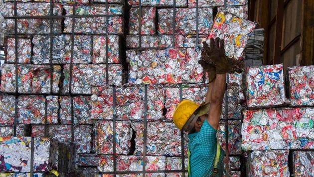 A worker piles recycled tin ‘bricks’ at La Sylvia recycling centre in Barva, province of Heredia, Costa Rica. The country discards 564 tons of plastic per day of which only 14 are recycled. Since April, a program seeks to stimulate recycling by giving value to waste through the exchange of it for a virtual currency that allows users to make purchases at partner stores. (Ezequiel Becerra / AFP) A worker piles recycled tin ‘bricks’ at La Sylvia recycling centre in Barva, province of Heredia, Costa Rica. The country discards 564 tons of plastic per day of which only 14 are recycled. Since April, a program seeks to stimulate recycling by giving value to waste through the exchange of it for a virtual currency that allows users to make purchases at partner stores. (Ezequiel Becerra / AFP)