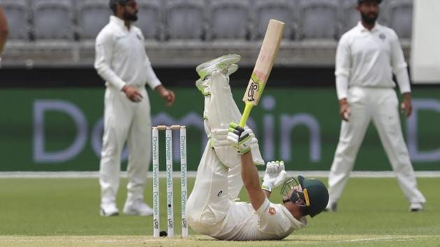 Australia's Tim Paine lies on the pitch after falling while avoiding a short ball from India's Mohammed Shami. (AP) Australia's Tim Paine lies on the pitch after falling while avoiding a short ball from India's Mohammed Shami. (AP)