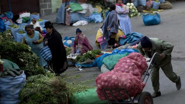 A man pushes sacks of onions at a street market in La Paz, Bolivia. For now, most of the produce that arrives in the early mornings at the markets in La Paz is often contaminated. An audit by the comptroller general said that out of a sample, “12.5% of agricultural products were acceptable; 25% were mildly acceptable; and 62.5% were rejectable.” (Juan Karita / AP) A man pushes sacks of onions at a street market in La Paz, Bolivia. For now, most of the produce that arrives in the early mornings at the markets in La Paz is often contaminated. An audit by the comptroller general said that out of a sample, “12.5% of agricultural products were acceptable; 25% were mildly acceptable; and 62.5% were rejectable.” (Juan Karita / AP)