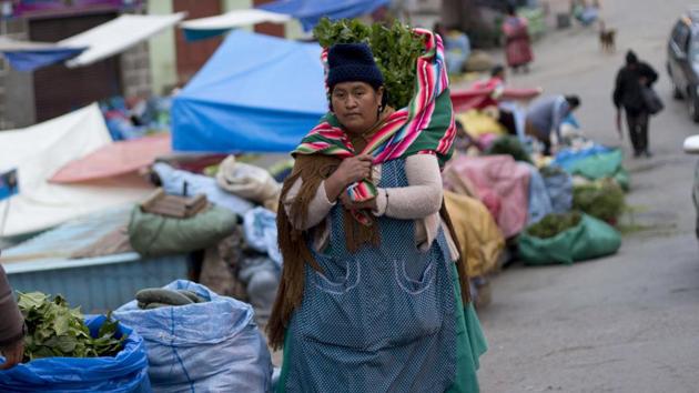 A woman carries celery and parsley she just bought at a street market in La Paz, Bolivia. Some of the samples carry parasites, including E.coli. Symptoms of E. coli infection include diarrhea, severe stomach cramps and vomiting. (Juan Karita / AP) A woman carries celery and parsley she just bought at a street market in La Paz, Bolivia. Some of the samples carry parasites, including E.coli. Symptoms of E. coli infection include diarrhea, severe stomach cramps and vomiting. (Juan Karita / AP)