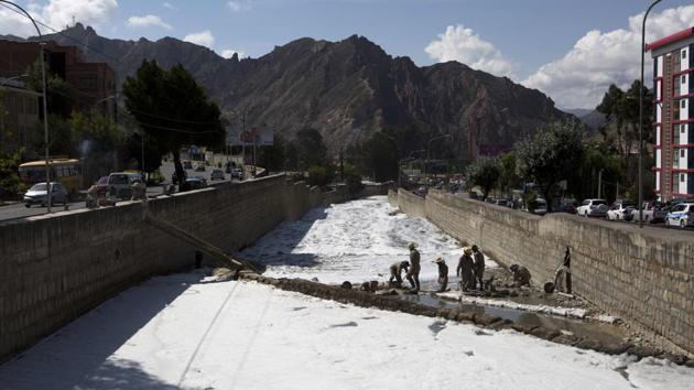 Men work in the polluted Choqueyapu River, covered by a white foam, in La Paz. Bolivia is one South America’s poorest countries and the world’s highest capital lacks a waste water treatment plant. The untreated fetid waters from households and factories flow into the Choqueyapu, Cotahuma and Orkohauira rivers that run from La Paz to the city’s southern agricultural hub. (Juan Karita / AP) Men work in the polluted Choqueyapu River, covered by a white foam, in La Paz. Bolivia is one South America’s poorest countries and the world’s highest capital lacks a waste water treatment plant. The untreated fetid waters from households and factories flow into the Choqueyapu, Cotahuma and Orkohauira rivers that run from La Paz to the city’s southern agricultural hub. (Juan Karita / AP)