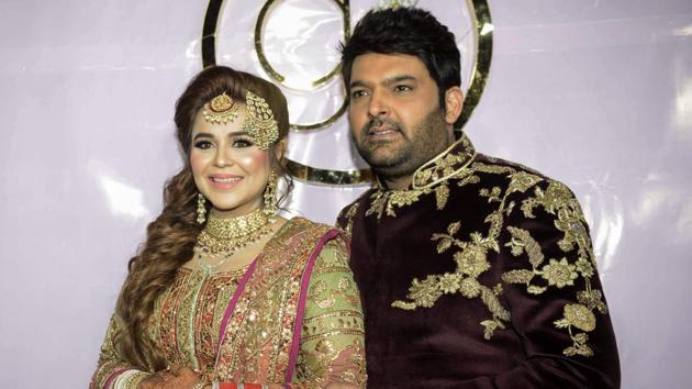 Kapil Sharma and his wife Ginni Chatrath pose during their wedding reception party at a hotel in Amritsar on December 14, 2018. (Photo by NARINDER NANU / AFP)(AFP)
