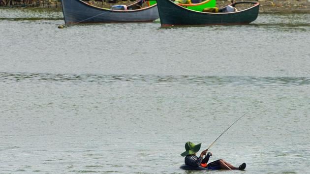 A man fishes while sitting in an inflated car tube on the Banda Aceh coast in Aceh province, Indonesia. (Chaideer Mahyuddin / AFP) A man fishes while sitting in an inflated car tube on the Banda Aceh coast in Aceh province, Indonesia. (Chaideer Mahyuddin / AFP)