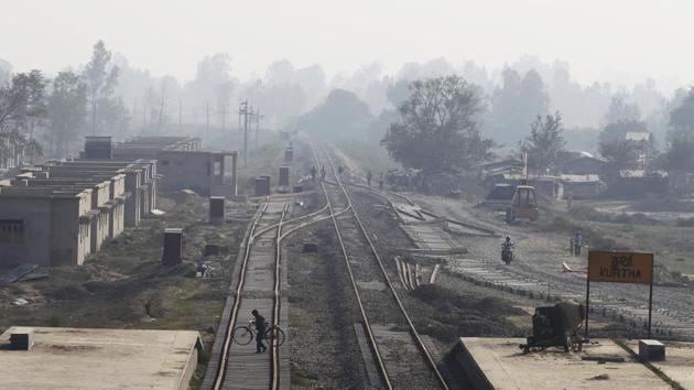 A Nepalese man carrying his bicycle crosses train tracks at Kurtha near Janakpur. The British built a narrow-gauge 2.5-foot wide track in 1937 to transport timber from Nepal. That train, with only three rusted carriages, windows lacking panes, missing doors and iffy service — the engine often broke down for days — quit running in 2014. (Niranjan Shrestha / AP) 