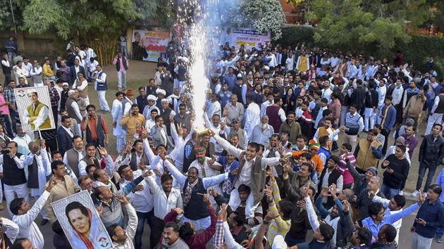 Congress party workers celebrate at Congress leader Ashok Gehlot's house after his name was designated for Rajasthan chief minister's post, in Jaipur(PTI)