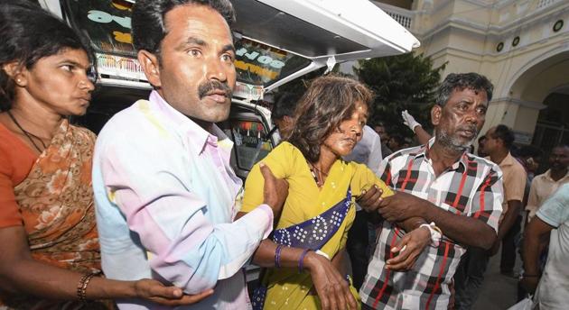 A woman is shifted to a hospital in as she complained of sickness after consuming 'prasad' at Maramma temple in Chamrajanagar district, in Mysuru on Friday, December 14, 2018.(PTI)