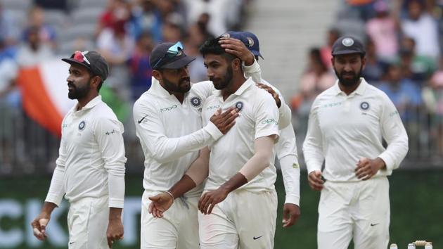India's Jasprit Bumrah, centre, is congratulated by teammate India's Murali Vijay after claiming the wicket of Australia's Marcus Harris during play in the second cricket test. (AP)