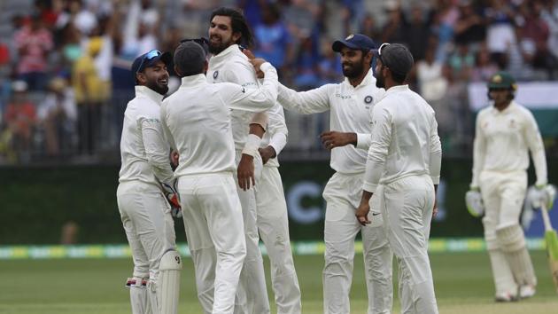 India's Ishant Sharma, third left, is swamped by teammates after he claimed the wicket of Australia's Peter Handscomb. (AP)