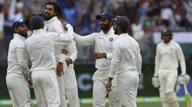 India's Ishant Sharma, third left, is swamped by teammates after he claimed the wicket of Australia's Peter Handscomb. (AP) India's Ishant Sharma, third left, is swamped by teammates after he claimed the wicket of Australia's Peter Handscomb. (AP)