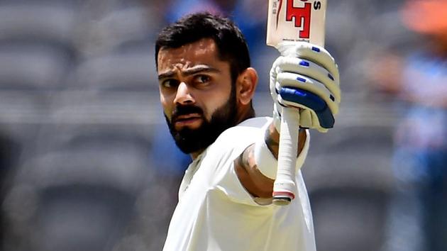 India's batsman Virat Kohli celebrates after scoring his century against Australia on the third day of the second Test match in Perth.(AFP)