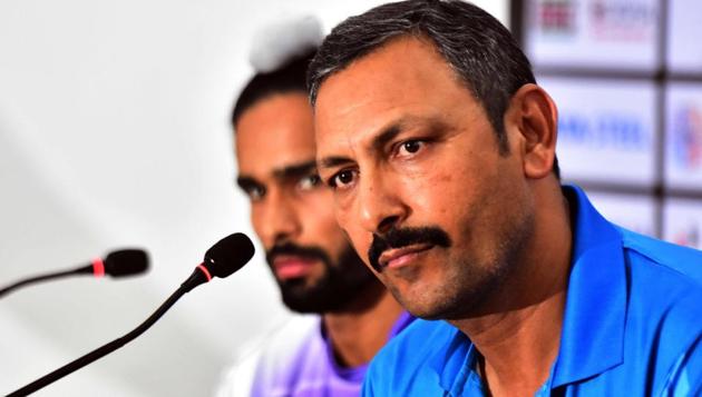 India's field hockey coach Harendra Singh (R) speaks next to player Akashdeep Singh (L) during a press conference.(AFP)
