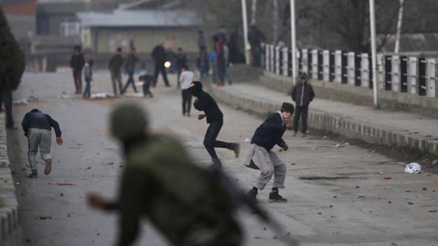 Kashmiri protesters throw stones at Indian paramilitary soldiers during a clash in Srinagar on Saturday.(AP)