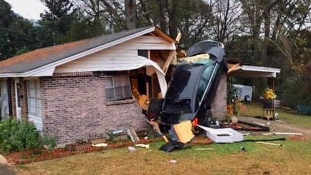 The scary photo shows the car almost upright against a wall of the house. (Montgomery Fire/Rescue/Facebook) The scary photo shows the car almost upright against a wall of the house. (Montgomery Fire/Rescue/Facebook)