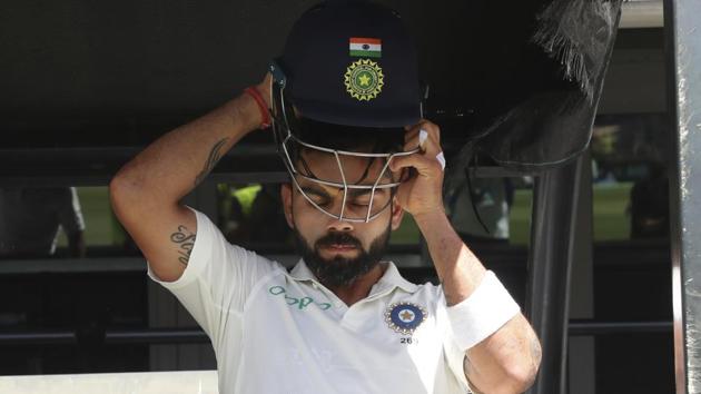 India's Virat Kohli fits his helmet before the second cricket test against Australia in Perth.(AP)