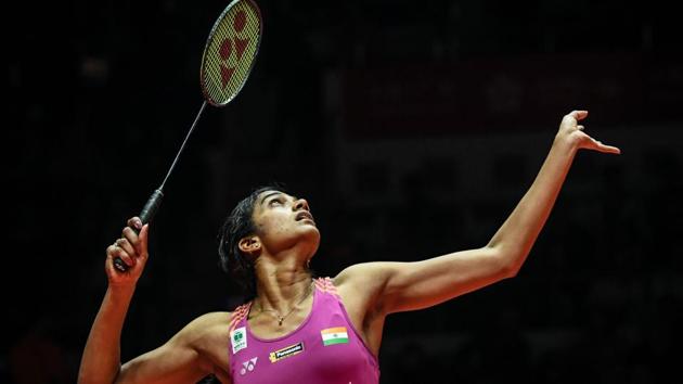 Sindhu Pusarla of India hits an overhead shot against Nozomi Okuhara of Japan during their women's singles final match at the 2018 BWF World Tour Finals badminton competition in Guangzhou.(AFP)