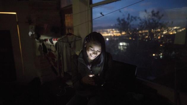 Emili Espinoza smiles during a video call with her children, in Bogota, Colombia. When Espinoza finally spoke to the 3-year-old son she hadn’t seen since fleeing Venezuela, little Elvis didn’t recognize her. His cold denial sent a shiver of sadness down her spine, overtaking joy. She reminded him of the chocolate-covered bananas she used to buy him, hoping to trigger a memory. But his young mind couldn’t grasp the recollection. (Ivan Valencia / AP) Emili Espinoza smiles during a video call with her children, in Bogota, Colombia. When Espinoza finally spoke to the 3-year-old son she hadn’t seen since fleeing Venezuela, little Elvis didn’t recognize her. His cold denial sent a shiver of sadness down her spine, overtaking joy. She reminded him of the chocolate-covered bananas she used to buy him, hoping to trigger a memory. But his young mind couldn’t grasp the recollection. (Ivan Valencia / AP)