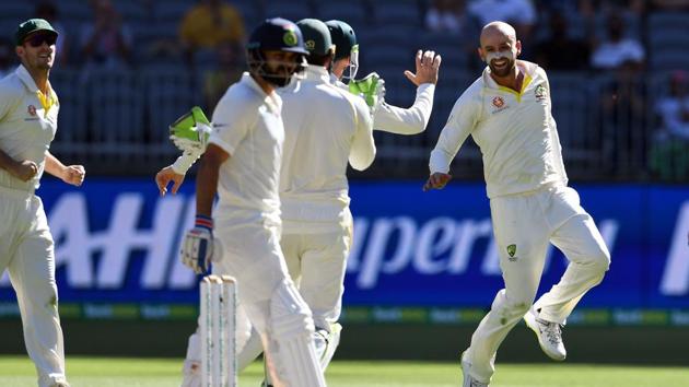 Australia's bowler Nathan Lyon (R) celebrates after dismissing India's Virat Kohli (C). (AFP)