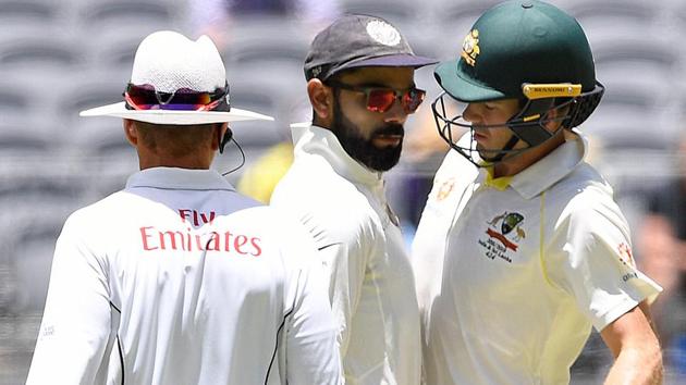 India's captain Virat Kohli (C) and Australia's captain Tim Paine react after Paine ran a single in Perth.(REUTERS)