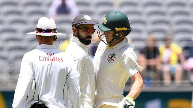 Virat Kohli (centre) and Tim Paine exchange words in the middle of the pitch at the Optus Stadium in Perth.(REUTERS)